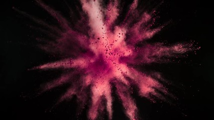 Super slowmotion shot of pink powder explosion isolated on black background.