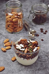 Chocolate and coffee yogurt granola in a plastic jar. Granola dessert for take away. Healthy street food granola  
