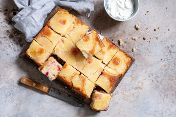 Upside down pineapple cake with cranberry on a table