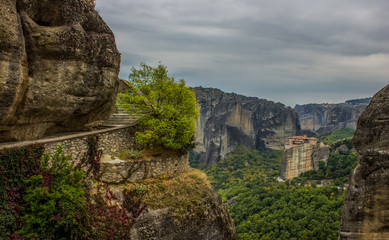 pilgrimage path way spiral stone stairs around steep mountain to highland Asian monastery somewhere in Nepal, cloudy dramatic weather 