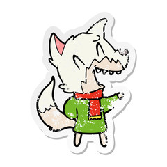 distressed sticker of a laughing fox wearing winter clothes