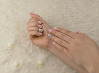 Stylish fashionable women pink manicure with feathers