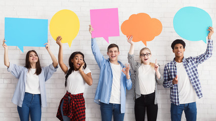 Speech bubbles. Happy friends holding empty placards