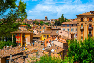 Fototapeta na wymiar Perugia, Italy - Panoramic view of the Perugia historic quarter with medieval houses and academic quarter of University of Perugia and other academies