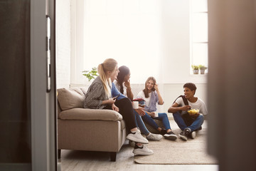 Fototapeta premium Young friends talking and spending time together