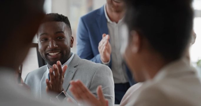 african american businessman celebrating with colleagues high five in office meeting having fun celebration sharing teamwork victory in workplace