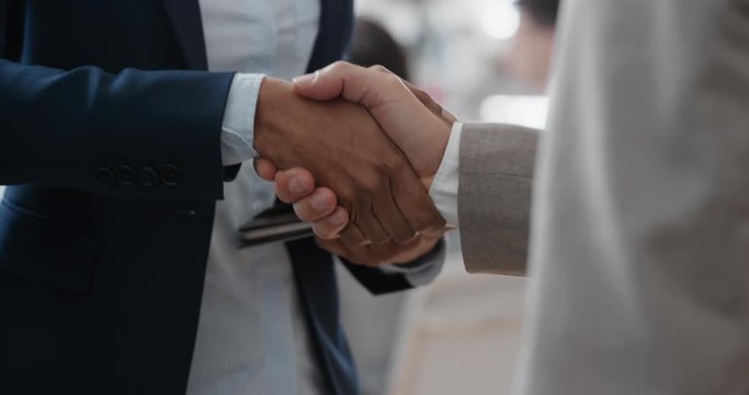close up business people shaking hands  corporate partnership deal welcoming opportunity for cooperation in office