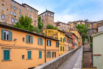 Fototapeta na wymiar Perugia, Italy - Panoramic view of the historic aqueduct forming Via dell Acquedotto pedestrian street along the ancient Via Appia street in Perugia historic quarter
