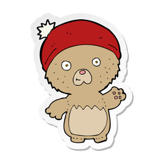 sticker of a cartoon cute teddy bear in hat