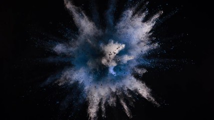 Super slowmotion shot of blue powder explosion isolated on black background.