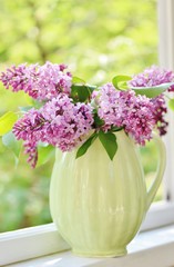 Bright lilac. A bouquet of colorful lilacs. Lilac in a vase. Place for text. Soft focus