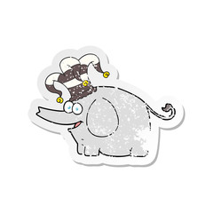 retro distressed sticker of a cartoon elephant wearing circus hat