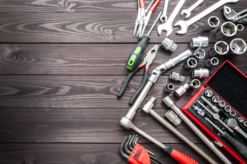 set of auto tools on dark wooden workbench. copy space