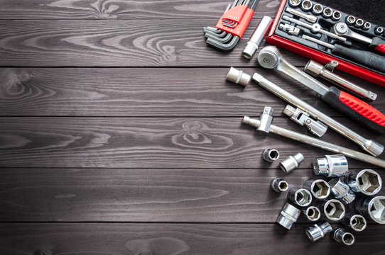 set of auto tools on dark wooden workbench. copy space