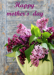"Happy mother's day" card with an inscription in English . Bright lilac. A bouquet of colorful lilacs. 