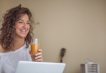 Young woman drinking orange juice