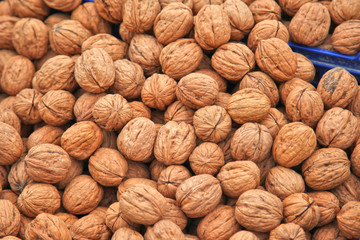 walnuts lie in a pile, natural harvest background