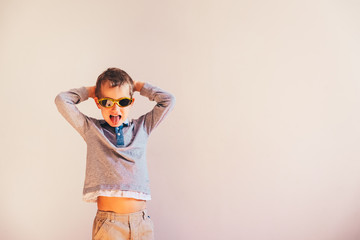 Child having fun gesturing and dancing, on white background and copy space.