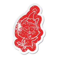 cartoon distressed sticker of a cat wearing santa hat