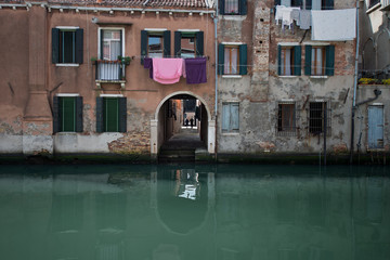 Fototapeta na wymiar Venice is a special town on the sea in Italy. Small romantic canal, old buildings and traditional venetian houses
