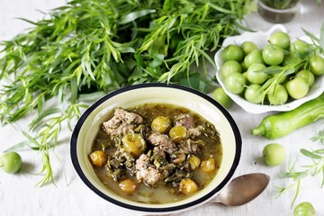 Meat stew with green plum  (tkemali) and greens. Georgian dish 