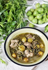 Meat stew with green plum  (tkemali) and greens. Georgian dish 