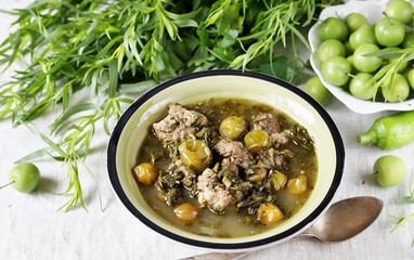 Meat stew with green plum  (tkemali) and greens. Georgian dish 