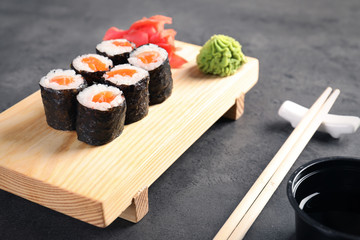 Tasty sushi rolls served on grey table. Food delivery