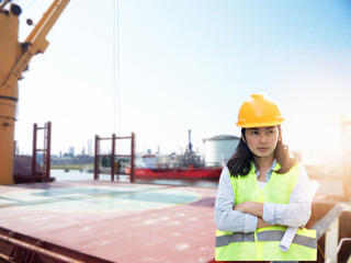 Women Engineering wearing hard hat and working at construction site