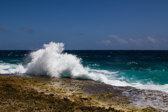 Wild and high waves breaking at the rough shoreline of the east coast of the caribbean island of Bonaire