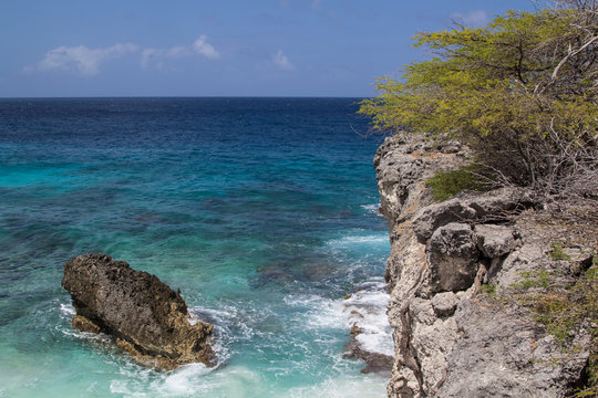 Crystal clear water, smooth surf  and a rocky coast on the north shore of the tropical island of Bonaire in the Netherlands Antilles