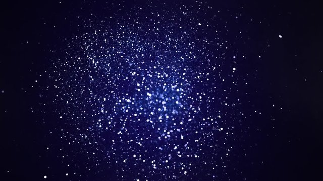 Silver glitter explosion in super slow motion on blue background.