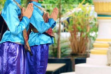 Asia young woman wearing traditional dress of Thailand pay respect
