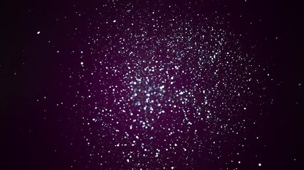 Silver glitter explosion in super slow motion on violet background.
