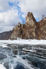 Fototapeta na wymiar Lake Baikal in winter. View from the ice on the beautiful cape Stolby (Pillars) on the 131 km of the Circum-Baikal Railway