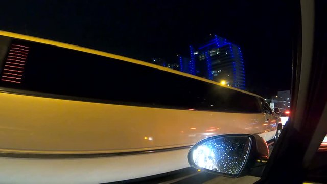 White limousine in a traffic jam in Miami at night. Southern Florida, USA