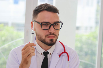Portrait of doctor holding syringe, the idea to show the medical academic education.