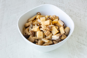 Fried mushrooms with oyster sauce on white background.