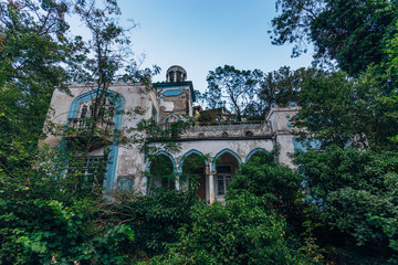 Fototapeta na wymiar Abandoned and overgrown mansion in oriental style. Concept of Tale 1001 Arabian Nights. Villa Dream, Crimea