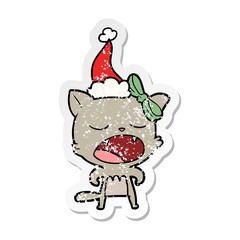 distressed sticker cartoon of a cat meowing wearing santa hat