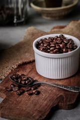 Coffee cup and beans on old kitchen table.
