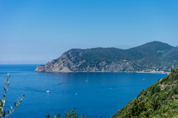 Fototapeta na wymiar Italy, Cinque Terre, Corniglia, a large body of water with a mountain in the background