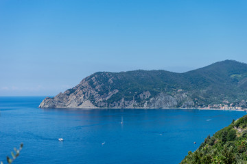 Naklejka na ściany i meble Italy, Cinque Terre, Corniglia, a body of water with a mountain in the background