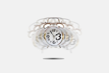 Time Management Concept : Silver alarm clock alerting on gray background.