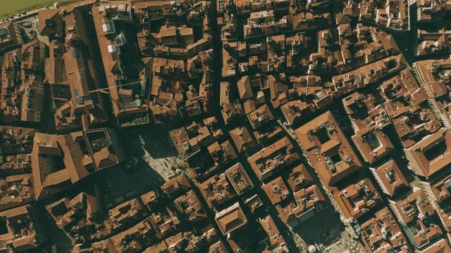 Aerial top down view of narrow streets, tiled roofs and squares in Florence, Italy