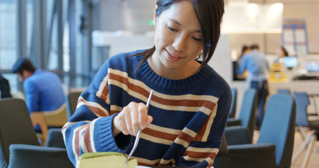 Fototapeta premium Woman enjoy her cake at coffee shop