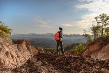 Fototapeta premium Tourist on the peak of high rocks. Sport and active life concept