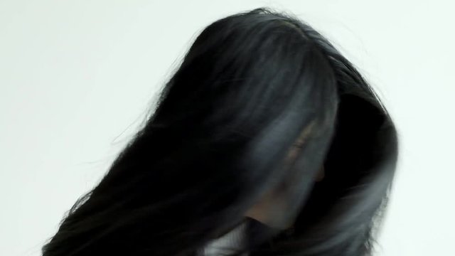 Slow motion of young beautiful asian woman spinning her head fast. Beautiful hair concept.