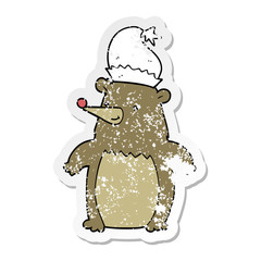 distressed sticker of a cartoon bear wearing christmas hat