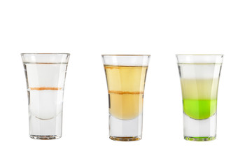 Set of alcohol shots on a white background. Three shots of alcoholic variety.